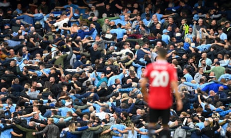 Manchester United’s Diogo Dalot looks towards Manchester City fans enjoying their team’s display on Sunday.