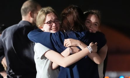 Alsu Kurmasheva, center, hugs her daughters Miriam Butorin, left, and Bibi Butorin upon her arrival on US soil.