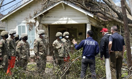 Donald Trump and the acting homeland security secretary, Chad Wolf, speak with national guard soldiers helping clean up after Hurricane Laura, in Lake Charles, Louisiana. 