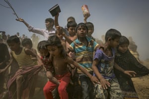 Chittacong, Bangladesh
Refugees rush for supplies at the Balu Khali Rohingya camp. Around 70,000 Rohingya Muslims have fled to Bangladesh from Myanmar since October last year.