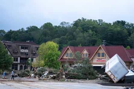 A car turned over amid storm debris.