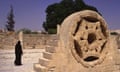A Palestinian woman walks past a reconstructed relief ornament in Khirbat al-Mafjar popularly known as Hisham's Palace an early Islamic archaeological site near Jericho, in the West Bank Israel. Image shot 2012. Exact date unknown.<br>D21PHA A Palestinian woman walks past a reconstructed relief ornament in Khirbat al-Mafjar popularly known as Hisham's Palace an early Islamic archaeological site near Jericho, in the West Bank Israel. Image shot 2012. Exact date unknown. FORGOTTEN PALESTINE
