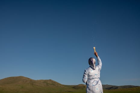 A woman with back to camera flicks milk skyward