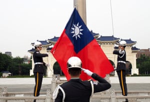 Taiwanese soldiers raise the flag of Taiwan in Taipei.