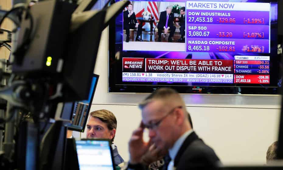 Traders work on NYSE floor as a TV shows the US president, Donald Trump, meeting France's president, Emmanuel Macron