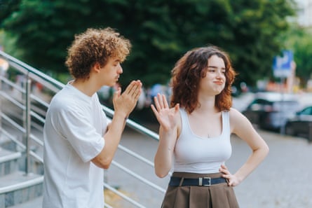 Guy pleads for forgiveness as girlfriend walks away upset in city An emotional guy tries to win back his girlfriend in a heated argument on a city street. She walks away, clearly done with the drama.