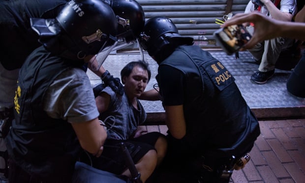 A Hong Kong protester is arrested by riot police officers during the clash. 