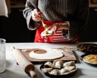 woman cooking polish dumplings at kitchen