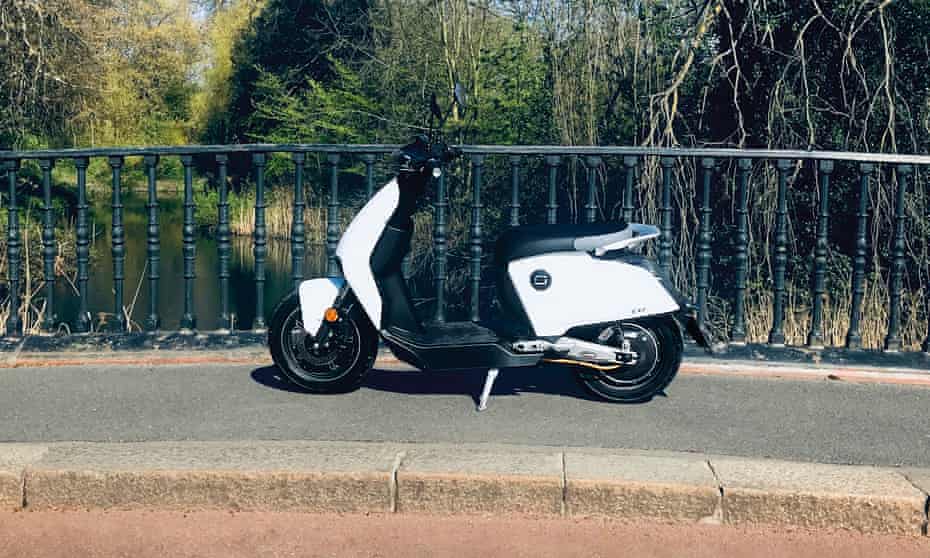 Super Soco electric scooter parked on a bridge