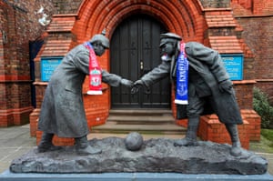Liverpool and Everton scarves adorn a Christmas Truce statue outside a church near Goodison Park.