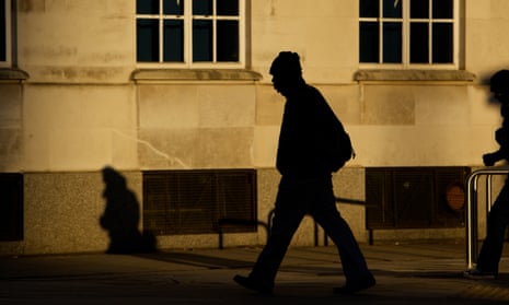 Silhouette of a man walking on an anonymous street. 