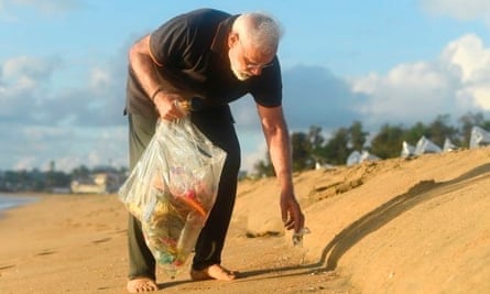 Prime Minister Narendra Modi collects rubbish from a beach in Mamallapuram.