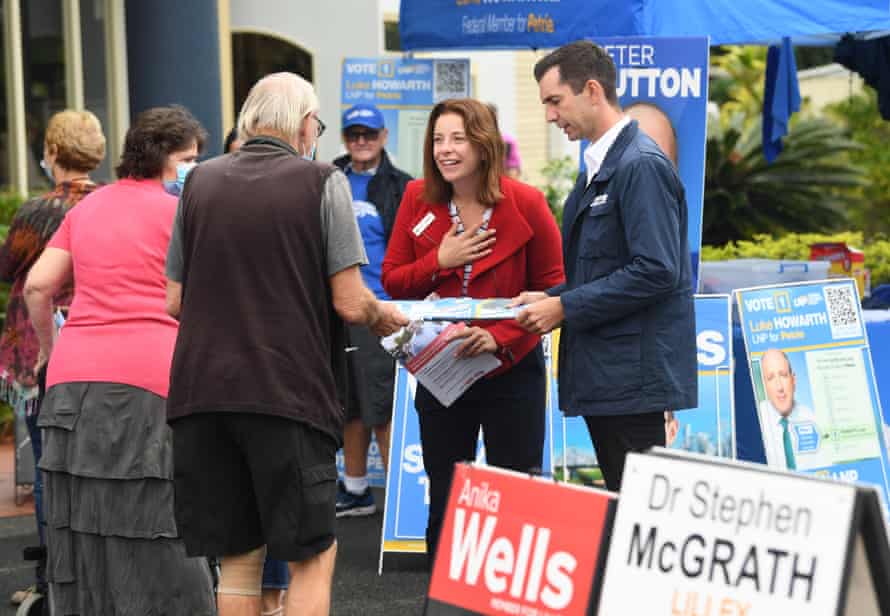 Federal member and Labor candidate for the seat of Lilley, Anika Wells (centre) and Federal member and LNP candidate for the seat of Brisbane, Trevor Evans (right) seen talking to voters at the pre-polling booth at the Chermside-Kedron Community Church in the federal seat of Lilley, in Brisbane.