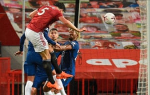 Harry Maguire (up) of Manchester United wins a header.