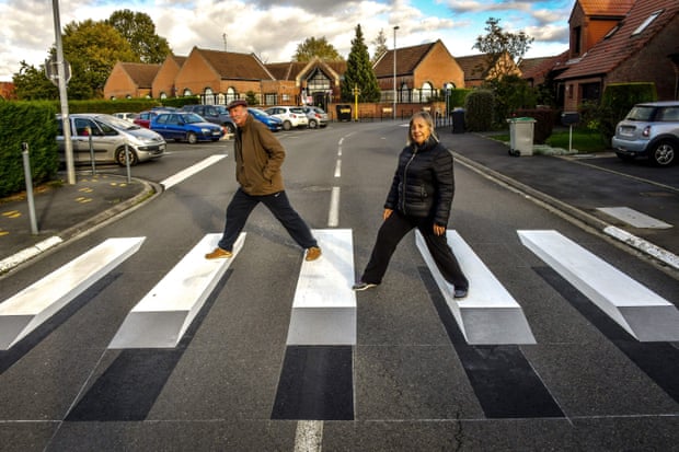 People cross the first 3D road crossing in France, created to encourage motorists to slow down in proximity to a school.