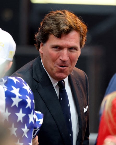 A man in a suit smiles while entering a stadium