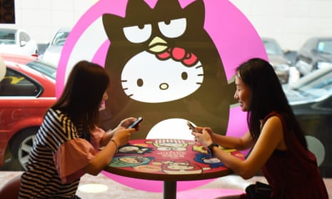 ‘An incredibly popular IP’ … patrons of a Hello Kitty theme restaurant, possibly playing the 2023 iOS hit Hello Kitty Island Adventure.