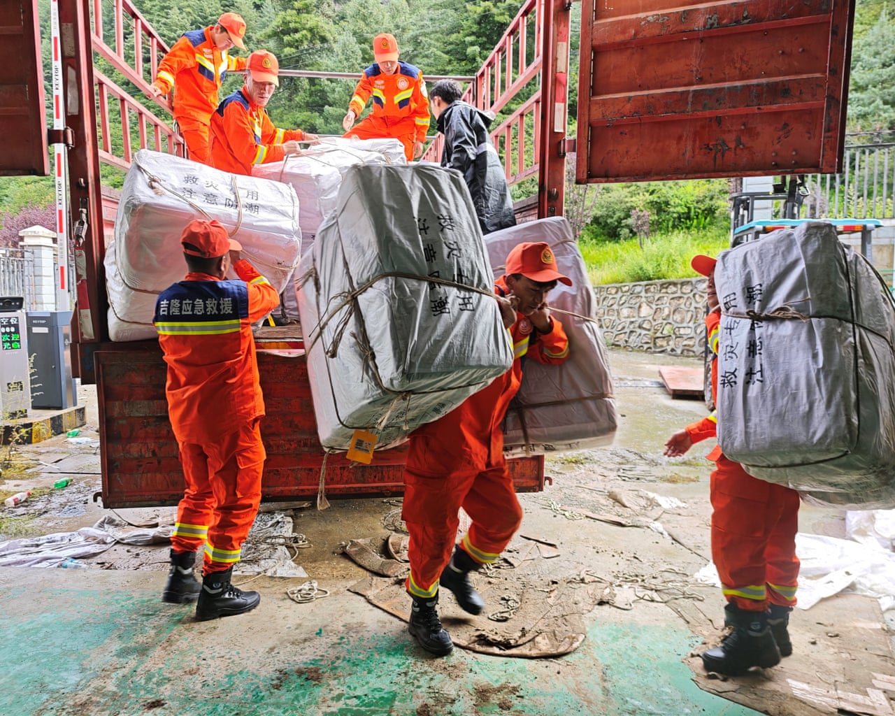 Rescue workers carrying relief supplies in Gyirong county in Shigatse, Tibet Autonomous Region, China, on Thursday
