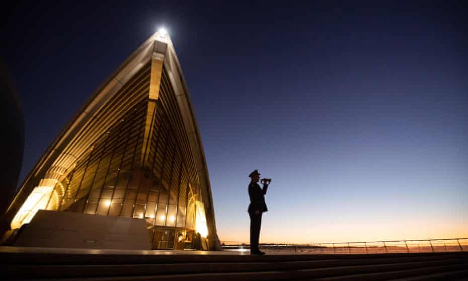 A lone bugler plays The Last Post on the steps of the Sydney Opera House on Anzac Day