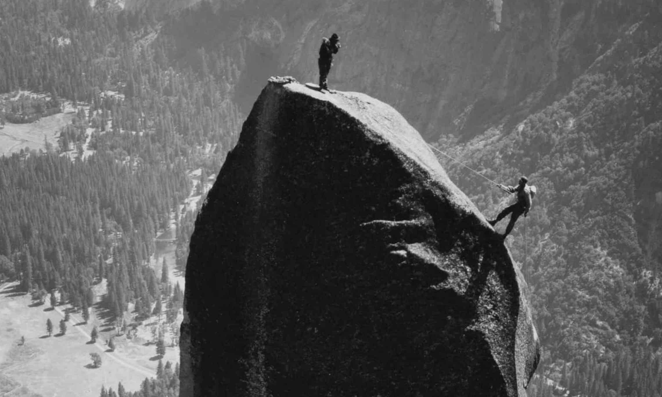 Two men climbing a rock in Yosemite Valley