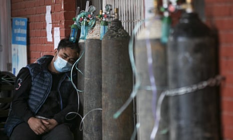 A COVID-19 patient receives oxygen outside a hospital in Kathmandu, Nepal, May 13, 2021.