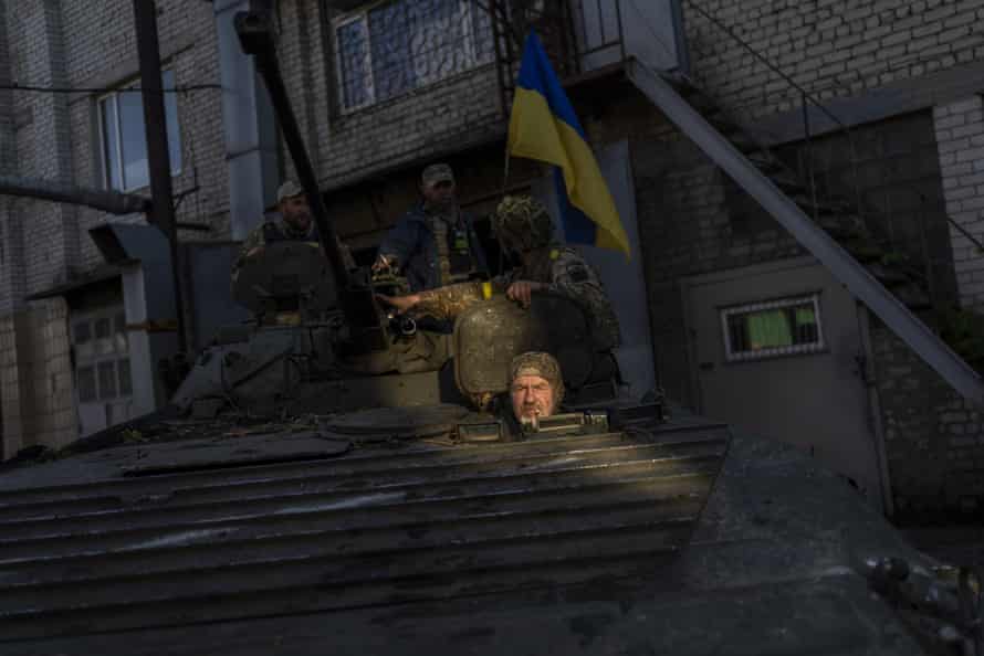 Ukrainian servicemen park a Russian BMP-2, an infantry combat vehicle, in the Kharkiv area, eastern Ukraine, on Sunday.