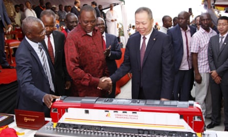 Kenyan President Uhuru Kenyatta, second left, and Chen Fenjian, president of CCC, shake hands at the opening of a Chinese-backed railway in Mombasa, Kenya, May 2017.