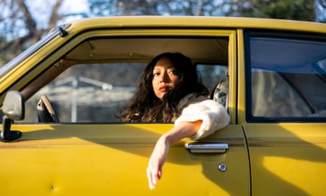 Shana Cleveland portrait, in a yellow car in the sunshine