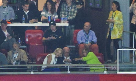 Elon Musk checks his phone during Super Bowl LVII in Glendale, Arizona.