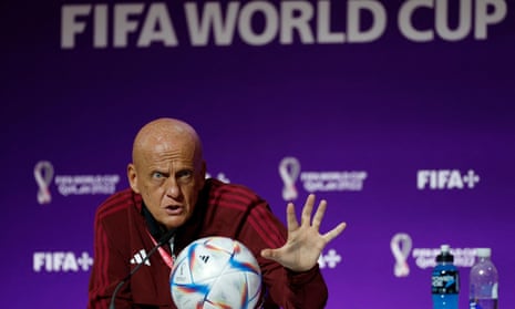 Pierluigi Collina looks intently at the World Cup ball.