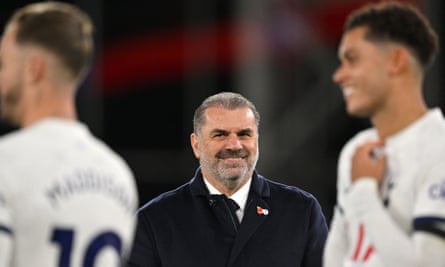 Tottenham manager Ange Postecoglou smiles on the sidelines
