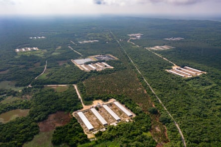 An aerial view of a series of industrial complexes in a green landscape