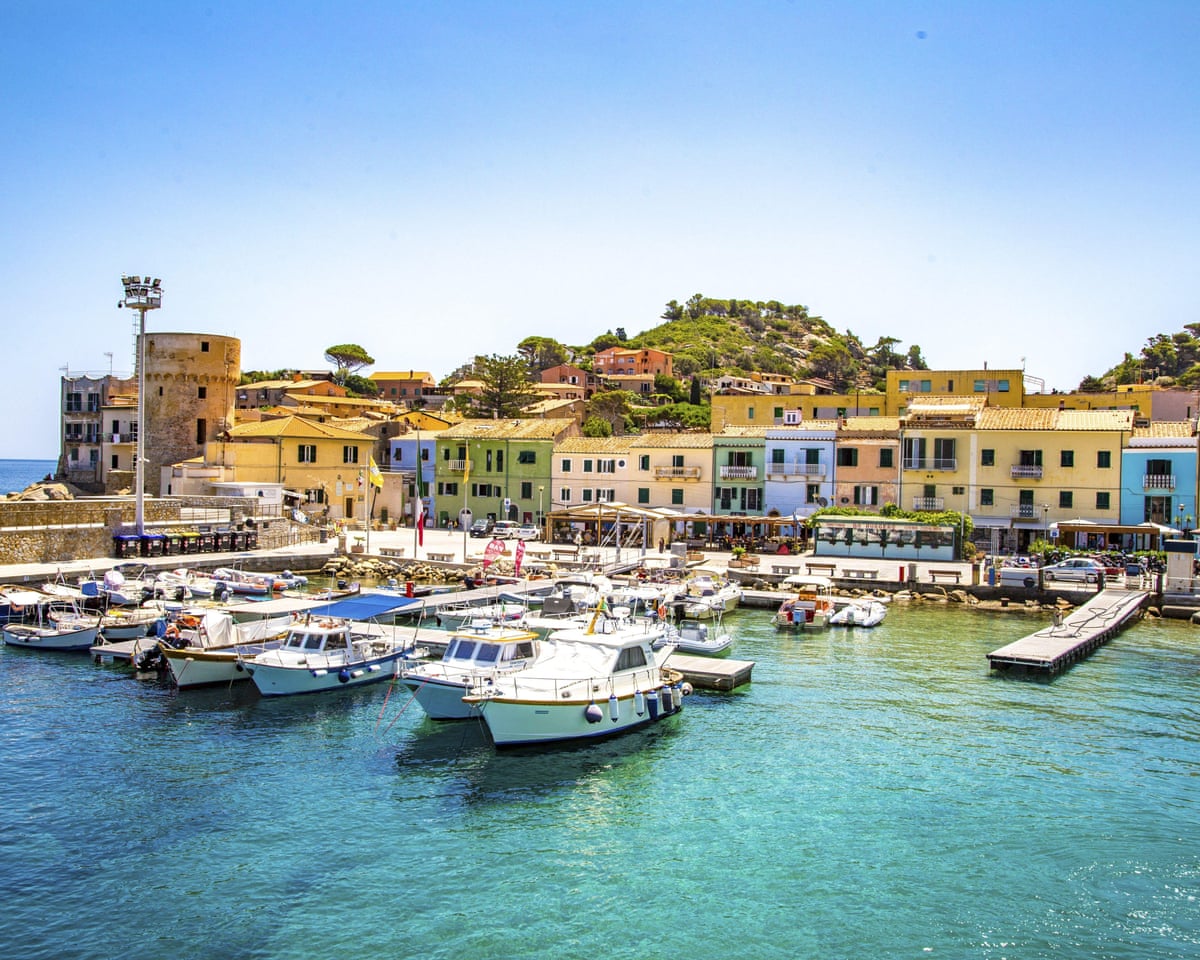 Port town of Giglio Porto with colorful row of houses and Saracen tower, Giglio Island, Tuscany
