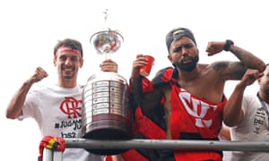 Rodrigo Caio and Gabriel Barbosa (right) celebrate with the Copa Libertadores in Rio. Barbosa scored both his team’s goals in the final in Peru.