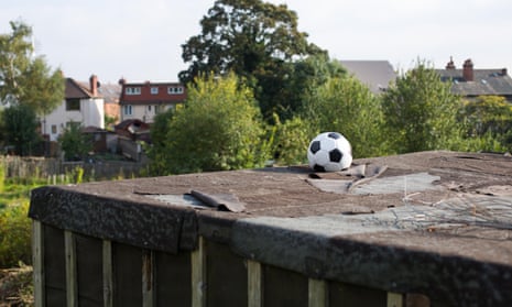 A lost football on top of a garage roof.