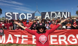 Protesters against the proposed Adani coalmine gather on the lawn of Parliament House in Canberra on 7 October.
