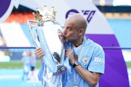 Pep Guardiola kisses the Premier League trophy in May 2024