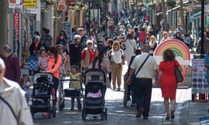 People walk without wearing face masks in Gibraltar.