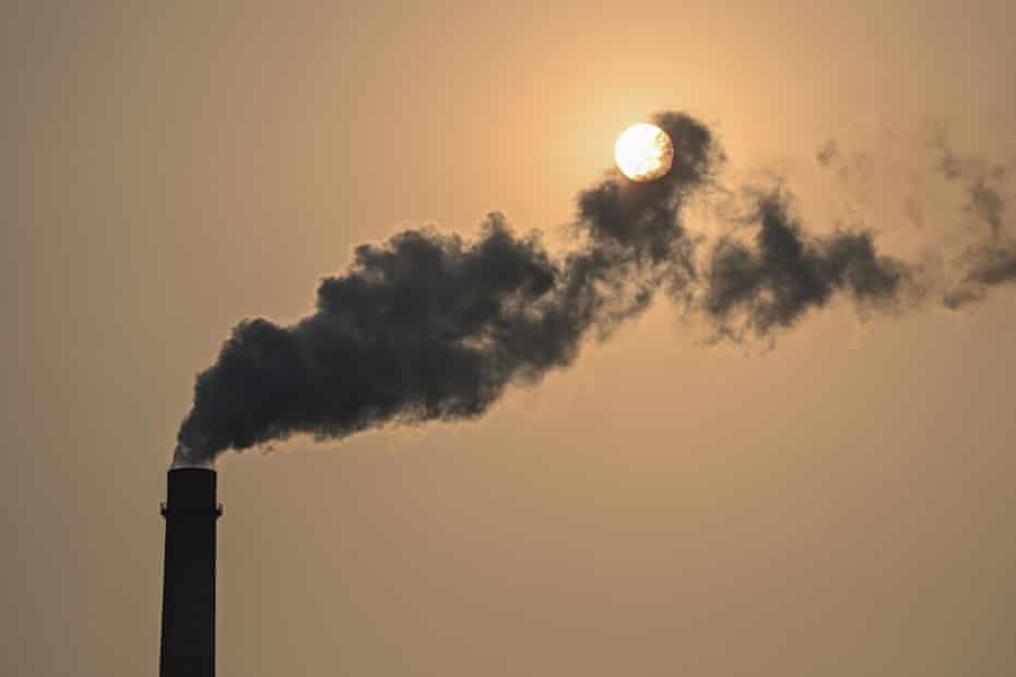 A silhouette of a coal smokestack 