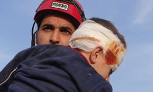 Abdullah rescuing a child from the rubble.