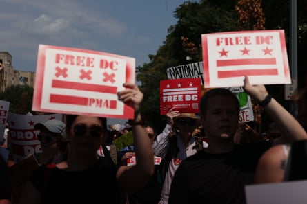people hold signs that read ‘free DC’