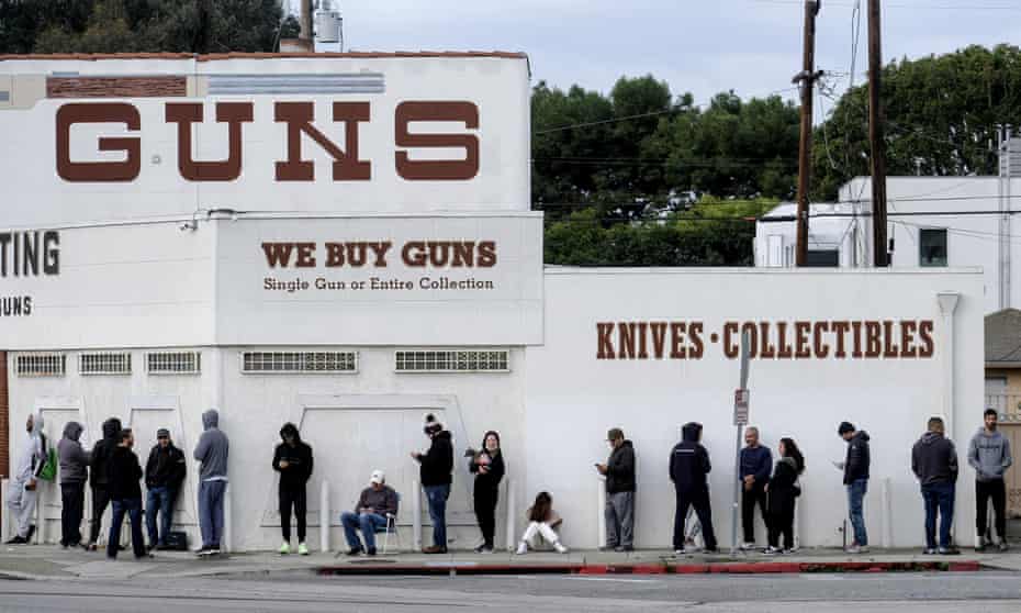 People wait in a line to enter a gun store in Culver City, California Sunday.