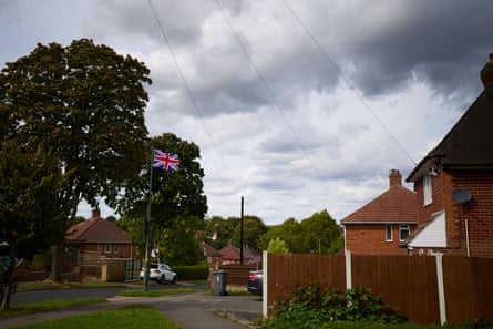 Flags fly in Weoley Castle in Birmingham.