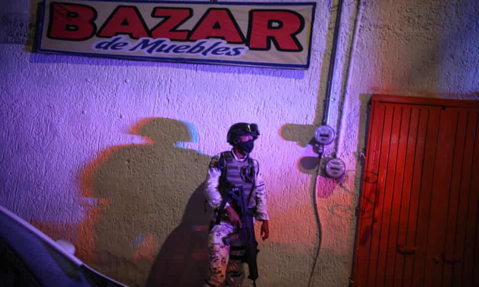 A soldier guards a crime scene in Guadalajara, September 2020. 