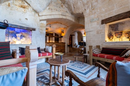 The stone lobby of a hotel-museum, with replicas of museum artefacts and furniture handmade to designs on ancient pottery