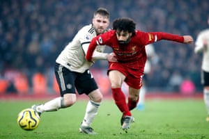 Liverpool's Mohamed Salah (right) and Manchester United's Luke Shaw fight for the ball.