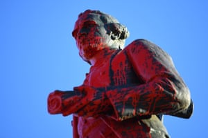 Red paint is seen covering a vandalised statue of Captain James Cook at Catani Gardens in St Kilda, Melbourne.