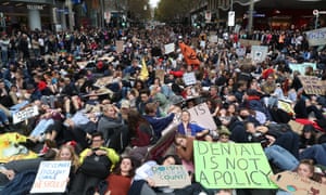 Protesters are seen lying down on Swanston Street in solidarity with the global climate strike in Melbourne on Friday.