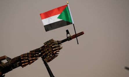 A Sudanese national flag is attached to a machine gun of Paramilitary Rapid Support Forces (RSF) soldiers.