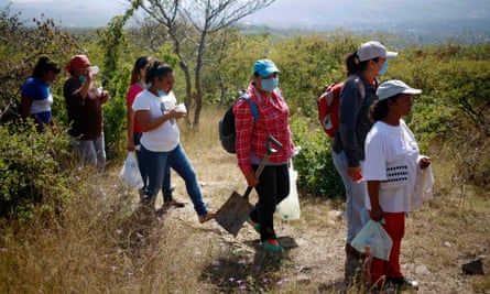 People with missing relatives walk to mass graves discovered in October, in La Joya on the outskirts of Iguala.